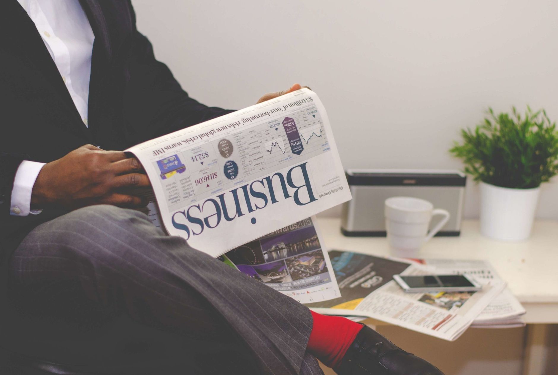 Businessman reading a financial newspaper at a desk, highlighting finance and commerce theme. — How Bitcoin Is Empowering Fin