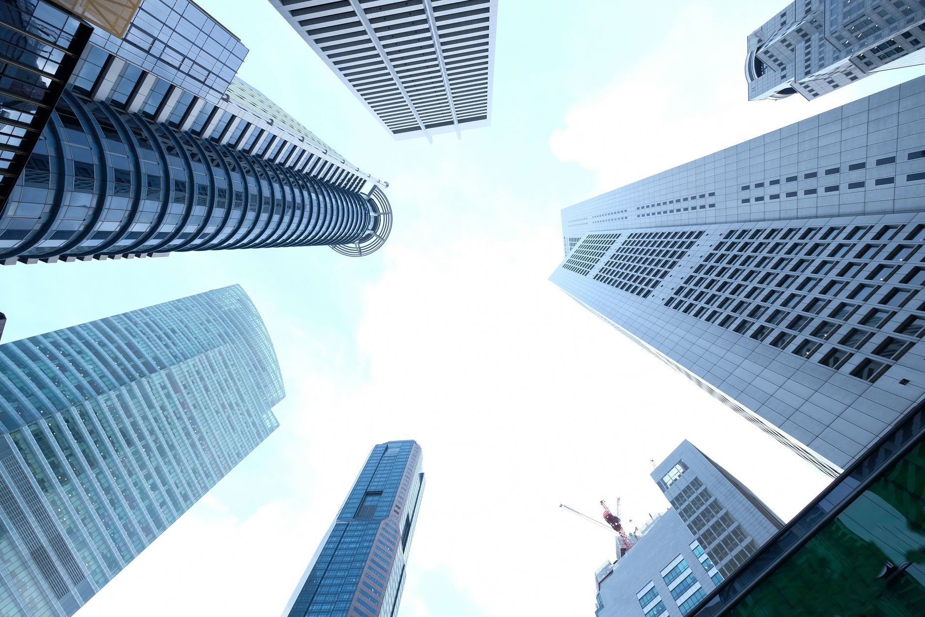 A striking upward view of various skyscrapers in an urban setting against a clear sky. — What are some of the benefits of cry