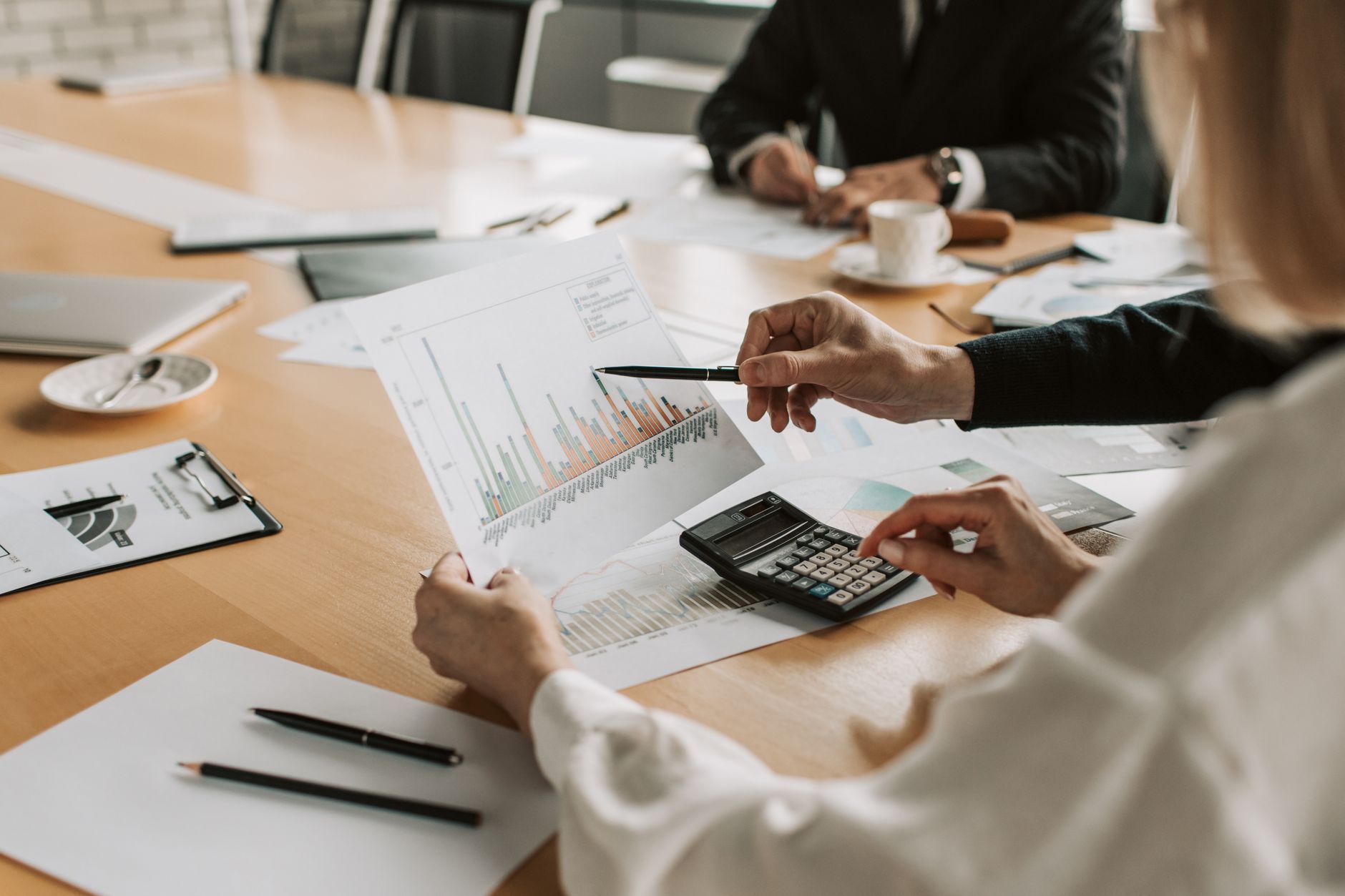 Professionals reviewing financial graphs and charts during a meeting. — What are the financial institutions that are involved