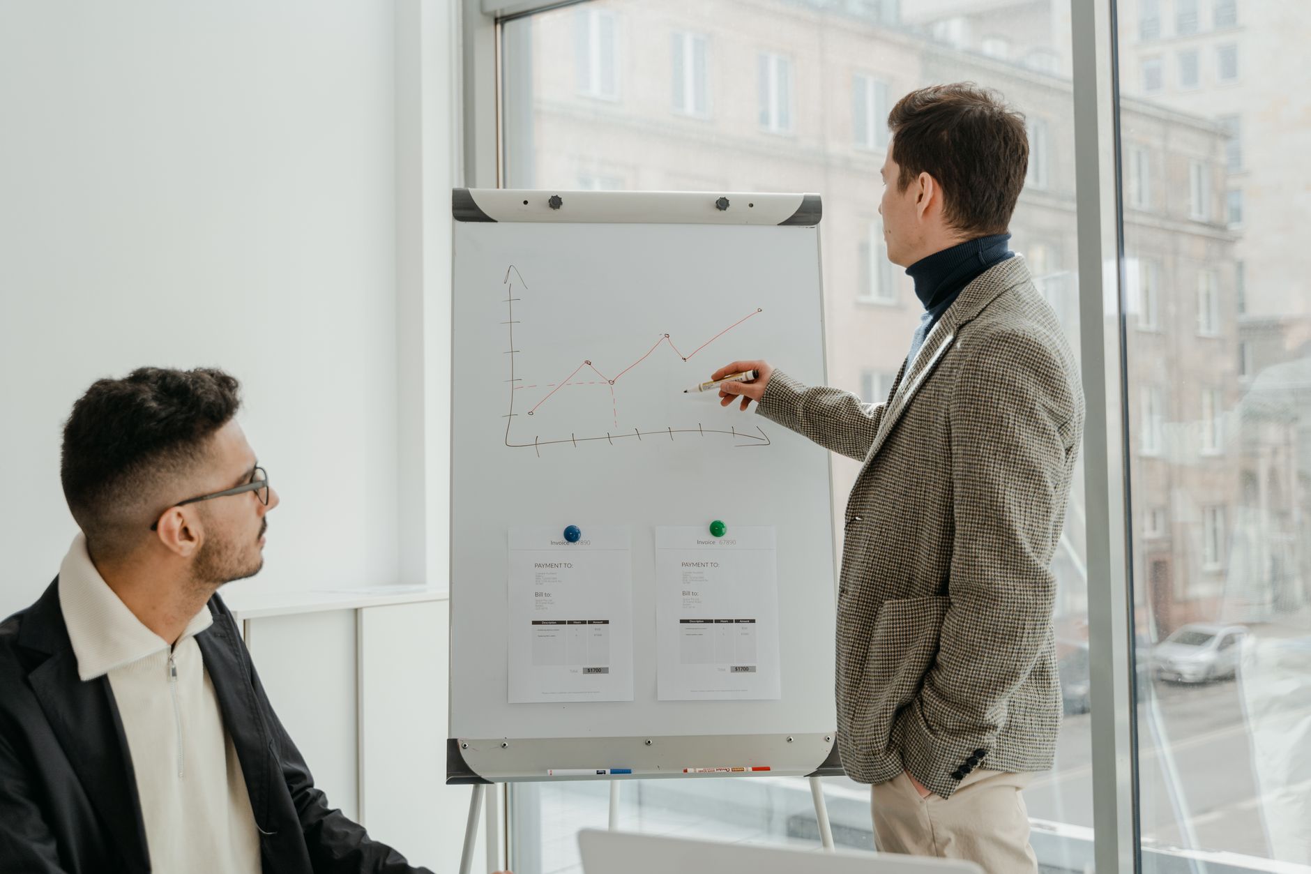 Two professionals examining graphs during an office presentation. — What Private Foundations Give Money to Youth Sports?
